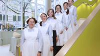 Nursing students lined up wearing vintage nursing uniform